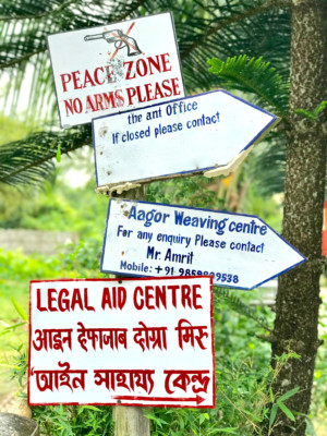 Signage at the gate of ‘the ant’ campus. The top-most sign is indicative of the once inherent risk of working in this region